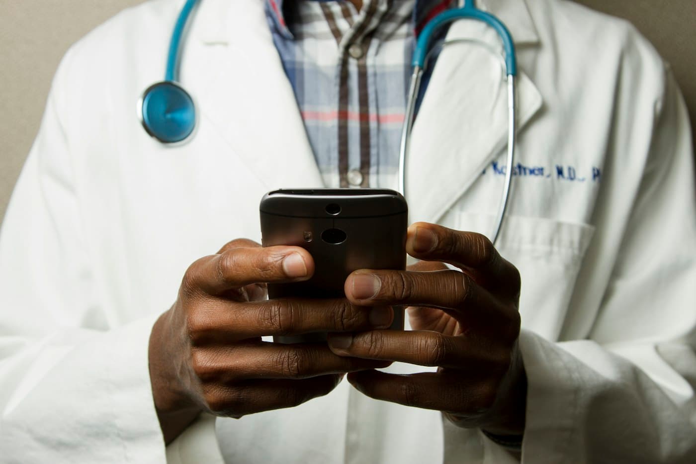 Illustrative close-up of a doctor using a phone
